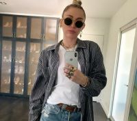 Miley Cyrus wears a thing with the Cody Simpson initials