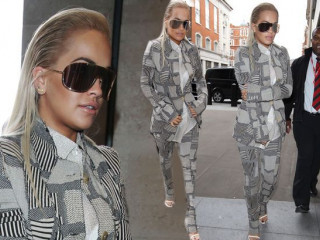 Rita Ora in Visor Sunglasses and a Grey Suit lands in London