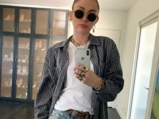 Miley Cyrus wears a thing with the Cody Simpson initials