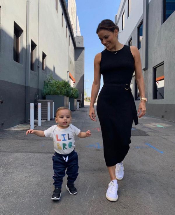 Eve Longoria walks with her young son