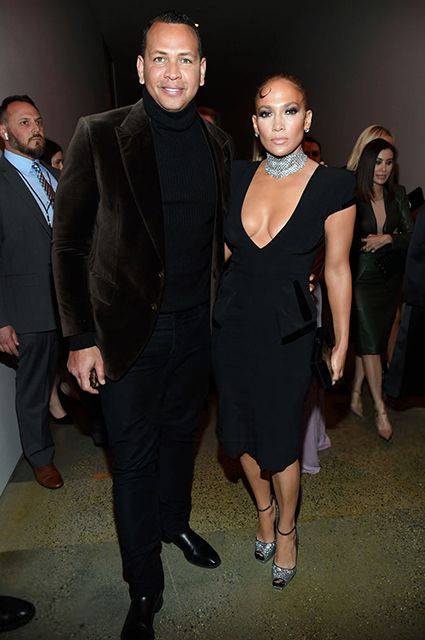 Jennifer Lopez attends a fashion show in a dress with a frank neckline